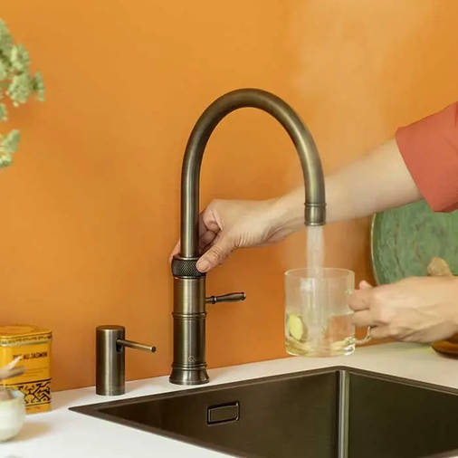 Multifunktionaler Wasserhahn in einer orangenen Küche